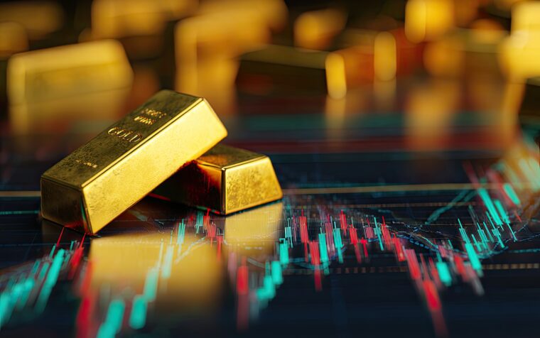 Close-up shot of two gold bars placed on a blurred background of a financial graph with gold